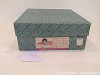 Closed original Madame Alexander doll box with label showing doll details.