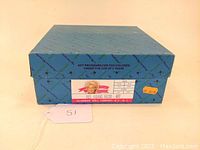 Original blue Madame Alexander box with label showing 'Red Riding Hood 482' and age warning