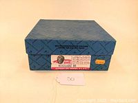 Closed blue box with labeling indicating 'Netherlands - 591' from Alexander Doll Company. Box includes a warning 'Not recommended for children under the age of 3 years' and price sticker.