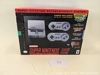 Front view of original box of the Super Nintendo Entertainment System Classic Edition, showing image of console and two controllers with highlighted games included.