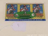 Front view of sealed tray showing three 20¢ wax packs with batter illustration and Topps logo