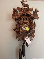 Front view of carved wood cuckoo clock