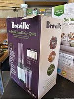 The Breville Boss To Go Sport smoothie maker boxed unit shown on a table with visible branding and product images.