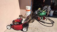 Side view of red Craftsman lawn mower with attached grass catcher and wheels.
