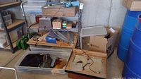 Overall view of light box, glass pieces bin and grinder on floor and shelving
