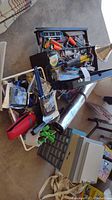 Photo showing additional hand tools in the toolbox including more pliers, cutting tools, and automotive supplies in bins and hardware organizers.