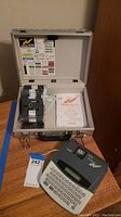 Brother P-Touch Extra label maker with tapes and manual in silver carrying case