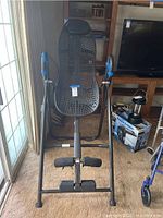 Front view of inversion table showing black mesh backrest and metal frame