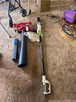 Full view of the Toro leaf blower and Oregon electric pole saw placed side by side on carpet, showing the size and design of both tools.