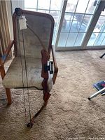 Full view of the Zephyr XE II recurve bow with string attached, resting on a chair.