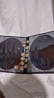 Open Morgan Silver Dollar Collection album with empty date slots and 14 coins placed in center