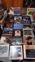 Overview of all 24 vinyl album covers spread on floor.
