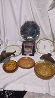 Full view of all items including plates, bowls, fish figurines, and boxed Spode cup.
