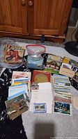 Full overview of the lot showing Texas Rangers comics stacked on top left, assorted postcards sorted around and in plastic bags.
