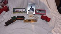 Full lot overview including HO scale train pieces, mug, whistle, boxed train memorabilia