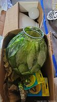 Green cracked look glass swag lamp in cardboard box with light bulbs and mounting hooks visible