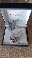 Sterling silver butterfly pin with blue-green enamel wings and pendant necklace with red stones and diamond inside Macy's branded box