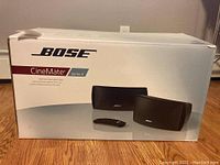 Box front showing Bose CineMate Series II branding and image of two speaker arrays with remote.