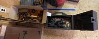 Box of assorted vintage woodworking hand tools placed next to Craftsman sander case