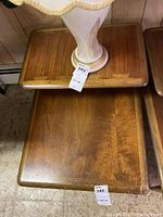 Photo showing the top and bottom tiers of one wooden mid-century modern side table with dovetail joinery and some surface wear.