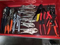 Drawer with various locking pliers, adjustable wrenches, pliers, and wire stripping tools.