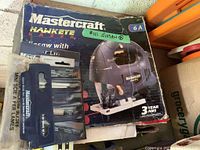 Box of Mastercraft Hawkeye laser jigsaw alongside a set of Mastercraft mini scie a fer jigsaw blades