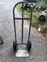 Front view of the metal hand truck showing the handlebar, vertical supports, and base plate.