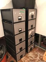 Front view of two stacked modular storage cabinets with 5 compartments each, showing drawer fronts with peeling and scratches