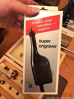 Photo of Bostik 260 Super Engraver in original packaging held by hand