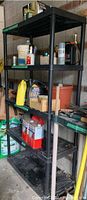 Full vertical view of entire shelving unit loaded with various tools and bottles, showing overall size and condition.
