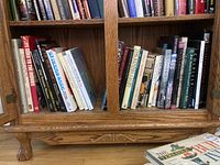Shelf of assorted hardcover books on various subjects including art, dogs, and history.