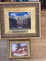 Full view of both framed prints, displaying their gilt carved frames and visible title plaques.
