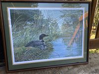 Full view of the framed print showing the duck near lakeside scene and condition of frame.