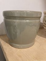 Medium green glazed ceramic plant pot showing smooth finish and size