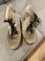 Top view of both boots showing fur exterior and lace closure