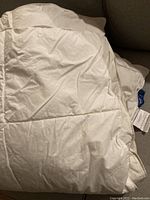 Comforter folded and showing cotton-covered polyester fabric with quilting.