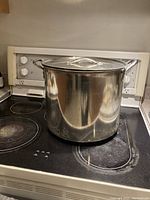 Stock pot with lid placed on stovetop, showing overall appearance and size.