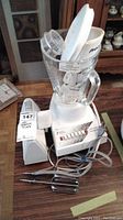 Full view of Proctor 7-speed blender showing blending jar, lid, and power cord, plus hand mixer beaters on table