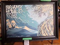 Full view of the framed winter scene painting showing tree branches with snow and distant mountains in muted blues and whites.