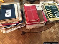 Top view of stacks of sheet music and bound song books showing titles and wear