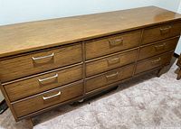 Front view showing nine drawers and metal handles