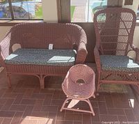 Front view of all three pieces - bench, rocker, and small chair shown together with cushions on bench and rocker, small chair without cushion.