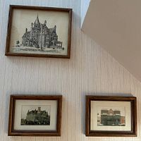 Three framed pictures depicting historic houses, mostly architectural drawings or paintings in wood frames