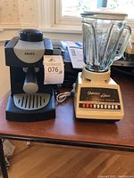 Krups espresso machine and Osterizer Galaxie blender on table showing front and side profiles.