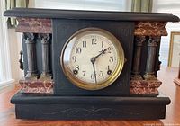 Front view of entire clock showing dial, case and decorative elements