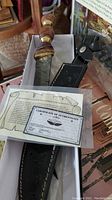 Photo of knife with sheath and certificate of authenticity in box