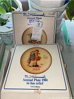 Photo of M.J. Hummel Annual Plate 1980 in original Goebel box, showing plate detail and year