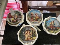 Overview of four octagonal Hummel plates with vivid illustrations of children in various outdoor scenes