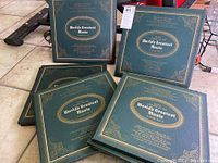 Photo showing multiple albums from the set with blue hardcovers and gold embossed titles labeled World's Greatest Music.
