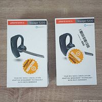 Two Plantronics Voyager 5200 headset boxes shown sealed and labeled with Amazon inspected sticker